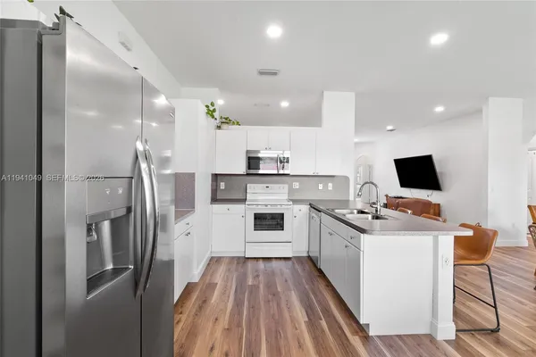 a kitchen with cabinets and a refrigerator