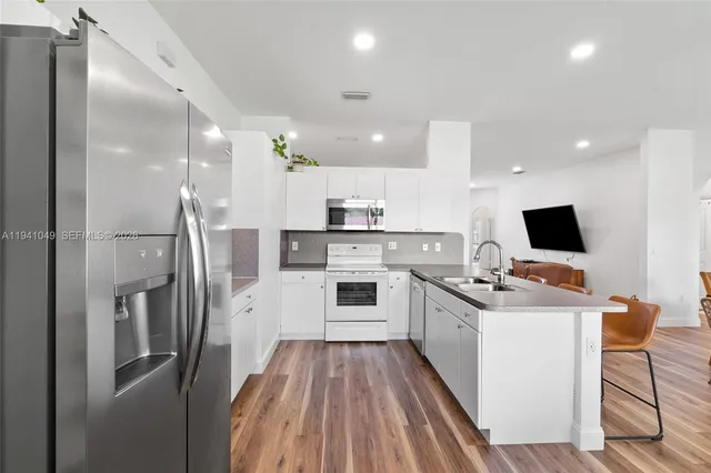 a kitchen with cabinets and a refrigerator
