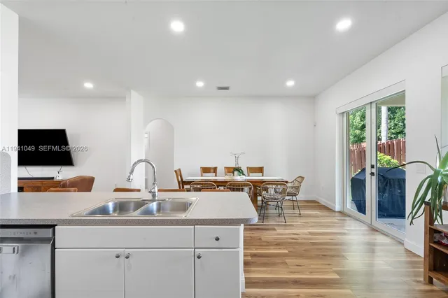 a kitchen with stainless steel appliances a refrigerator and a stove top oven