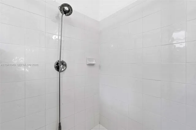 a bathroom with a sink a toilet a mirror and shower