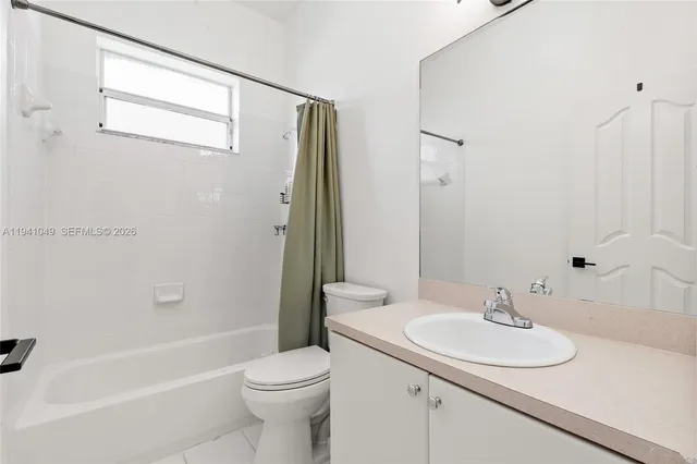 a view of a chair and table in backyard of the house