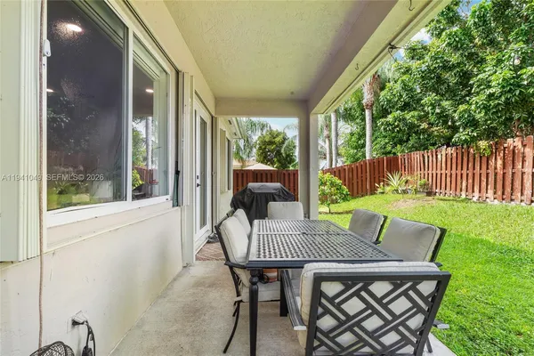 a view of a yard with wooden fence
