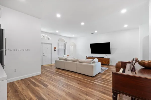 a living room with furniture and a flat screen tv