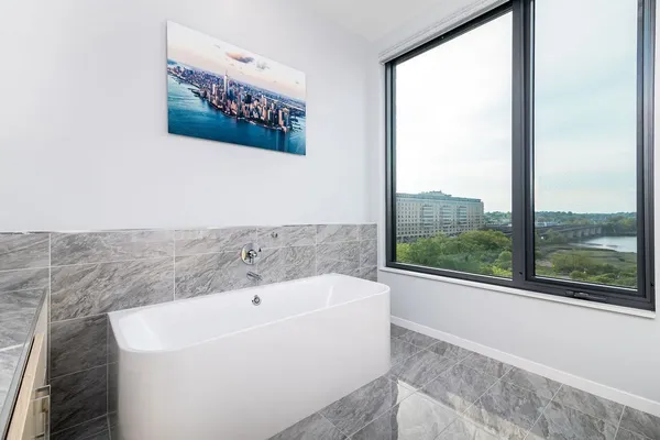 a white bath tub sitting next to a window