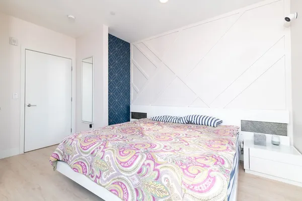 a bedroom with a bed and a mirror