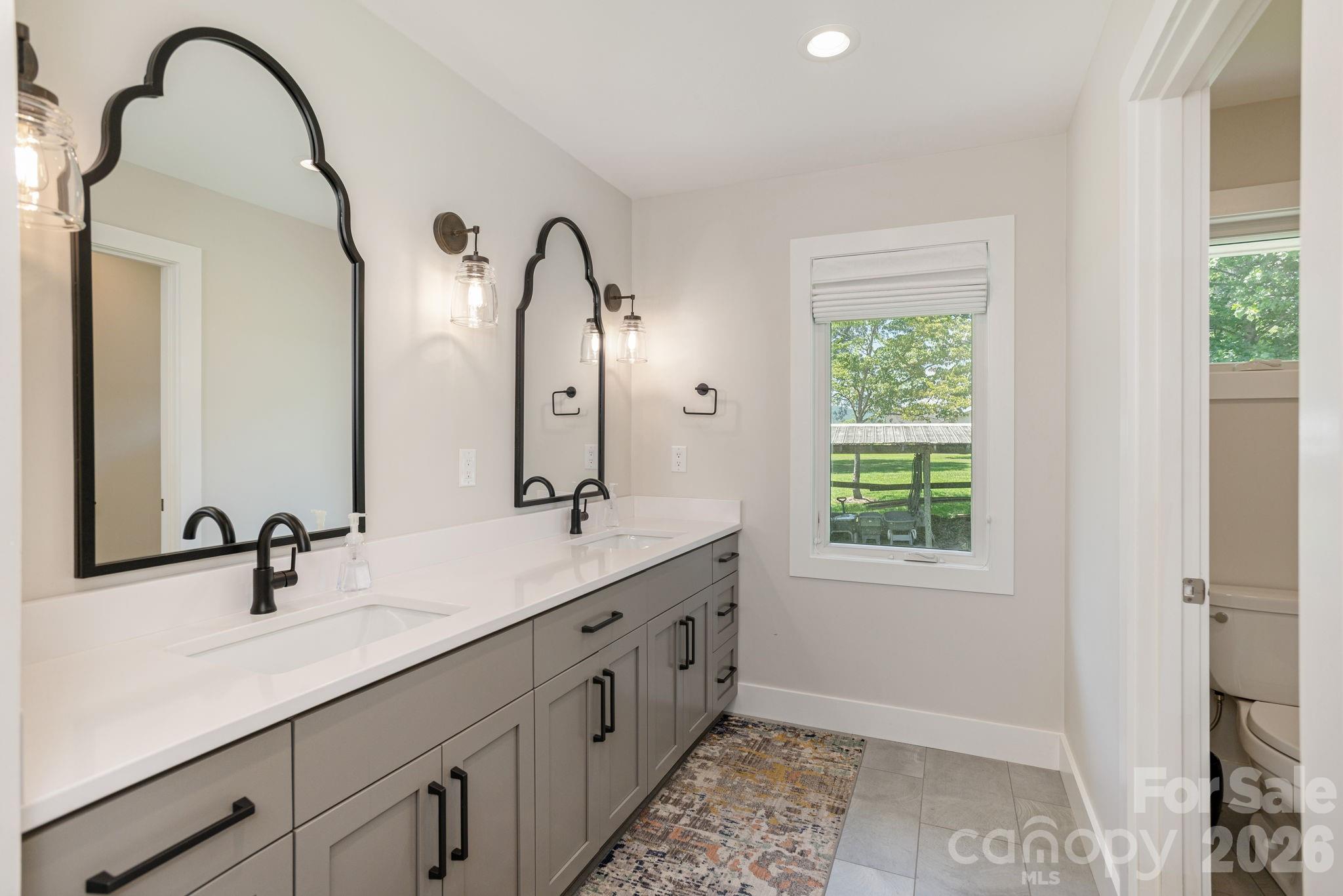 16 School House Road Mills River, NC 28759 - Photo 20 of 48 a bathroom with a double vanity sink and a mirror