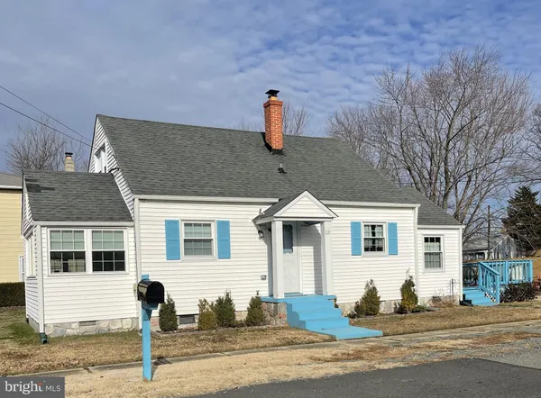 a front view of a house with a road