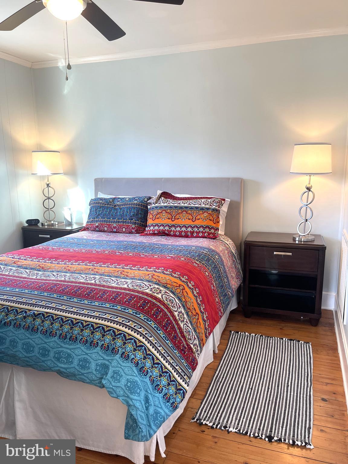 221 Madison Street Colonial Beach, VA 22443 - Photo 17 of 28 a bedroom with a bed and a lamp