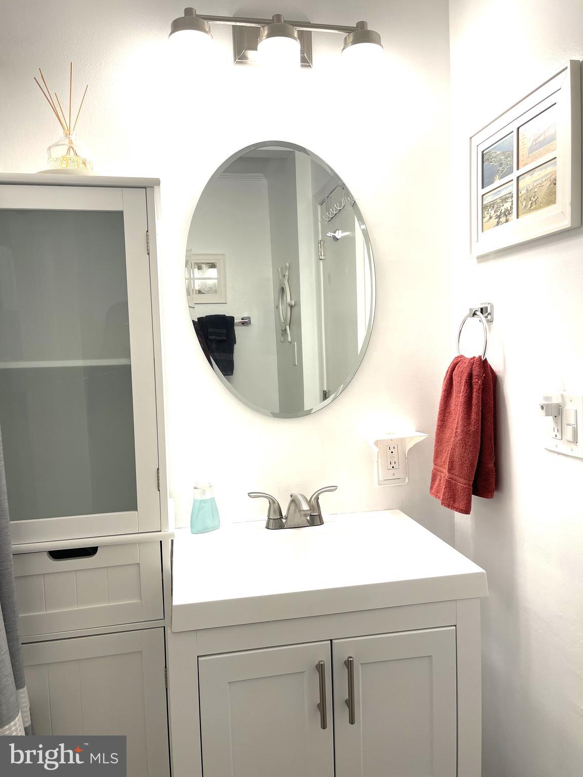 221 Madison Street Colonial Beach, VA 22443 - Photo 21 of 28 a bathroom with a sink and mirror