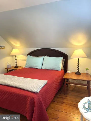 a bedroom with a bed and a night stand