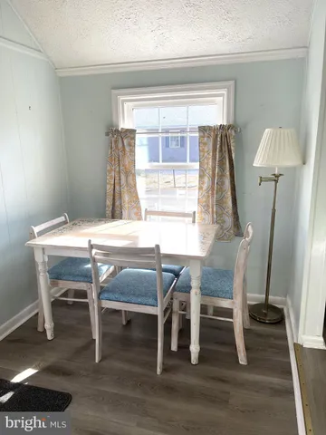 a dining room with furniture and wooden floor
