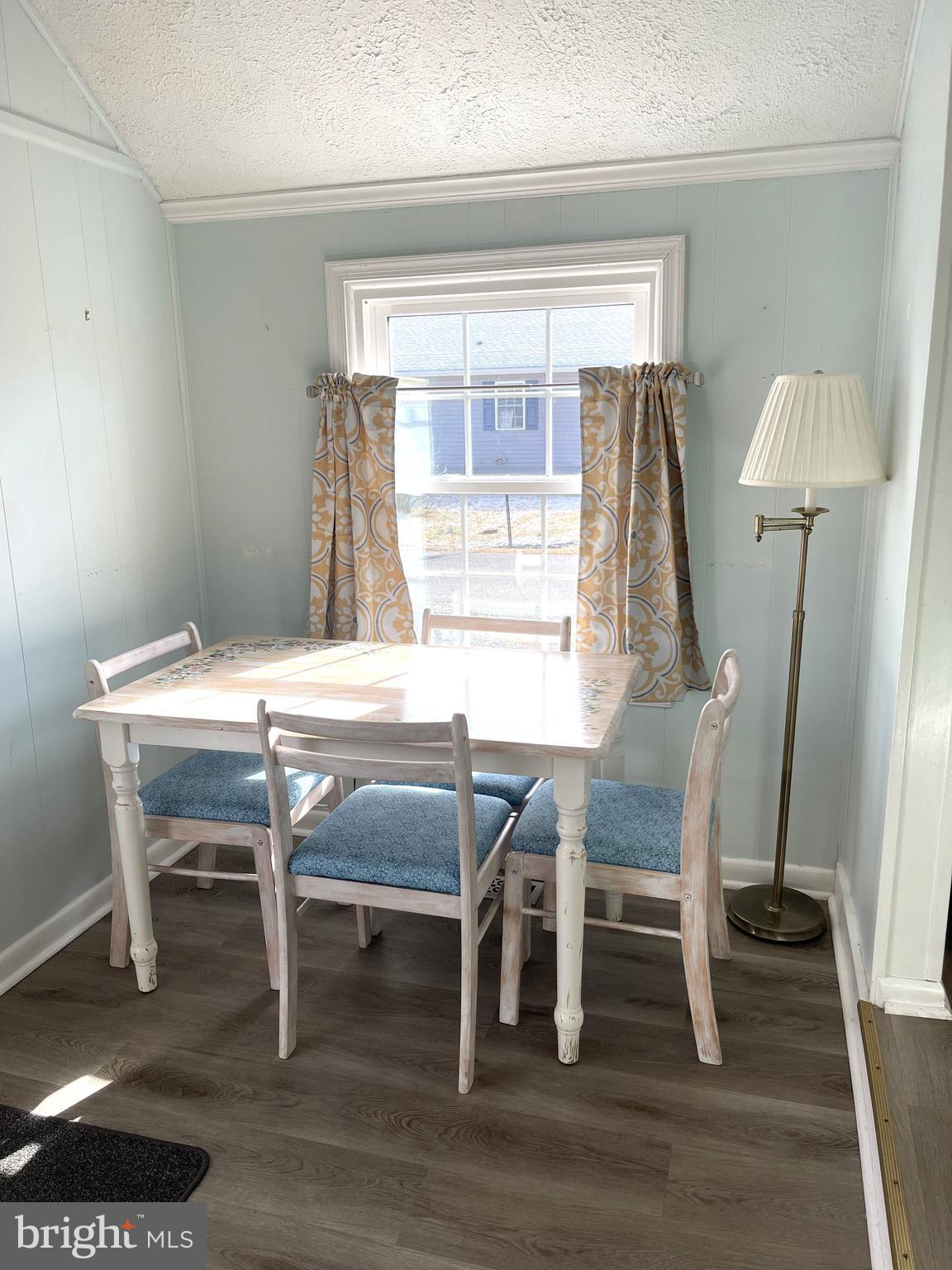 221 Madison Street Colonial Beach, VA 22443 - Photo 8 of 28 a dining room with furniture and wooden floor