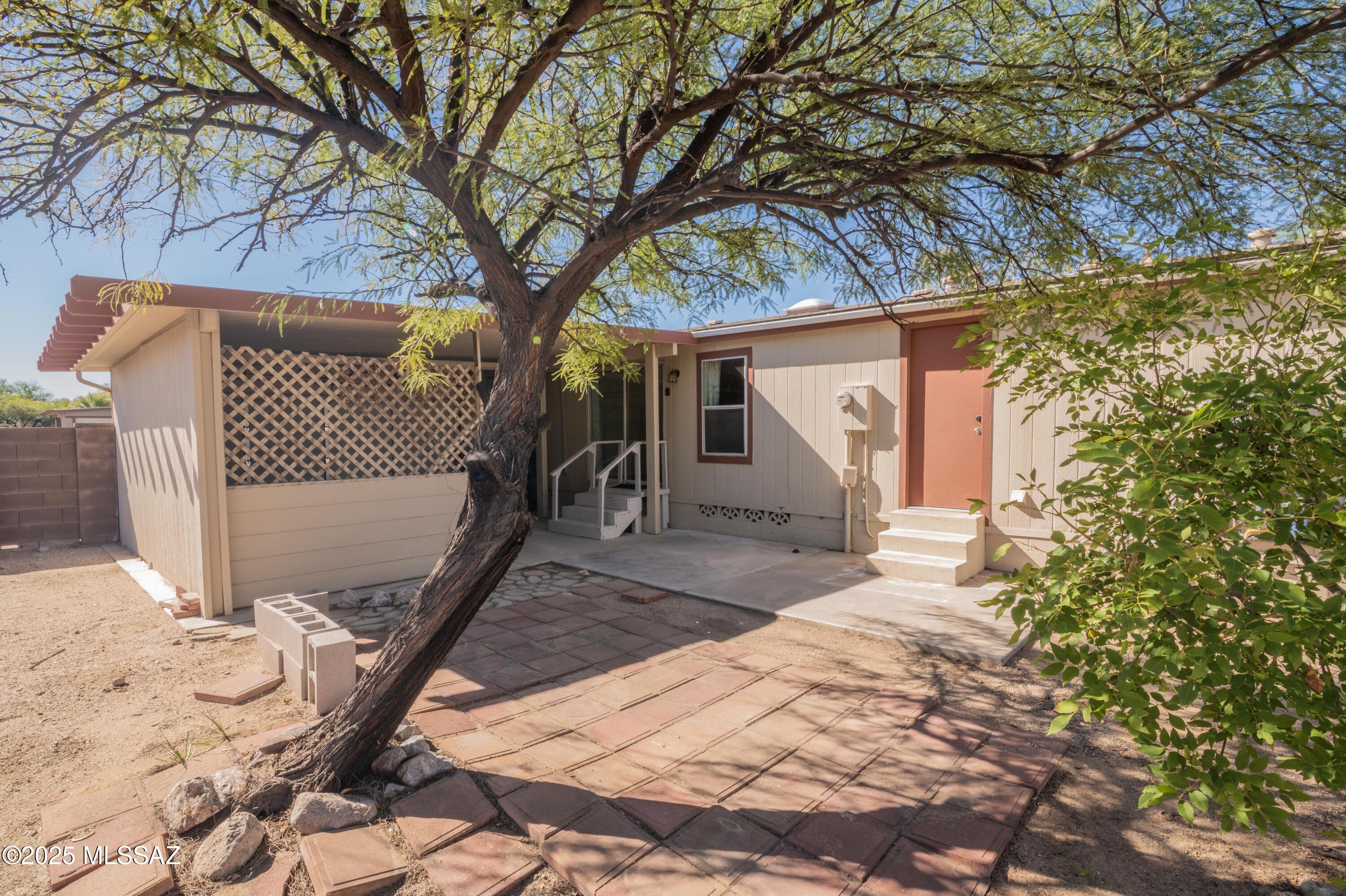 6205 East Rough Rock Drive Tucson, AZ 85756 - Photo 24 of 30 a front view of a house with a yard
