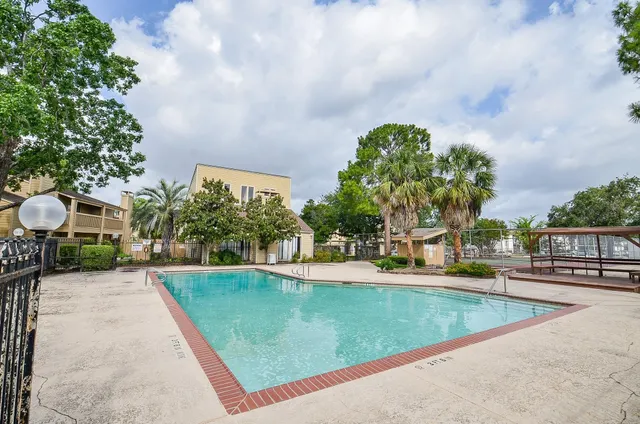 swimming pool view with a garden space