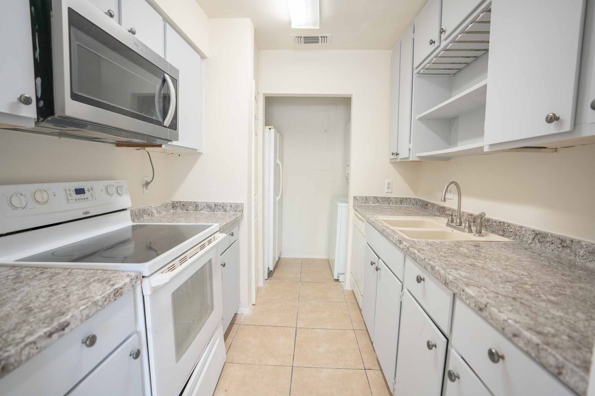 3632 Ocee Street Houston, TX 77063 - Photo 5 of 17 a kitchen with granite countertop a sink and a stove