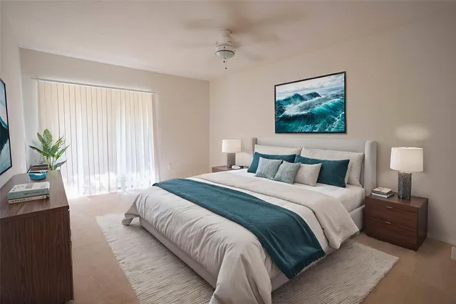 a bedroom with bed and a painting on the wall