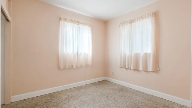 a view of an empty room and a window