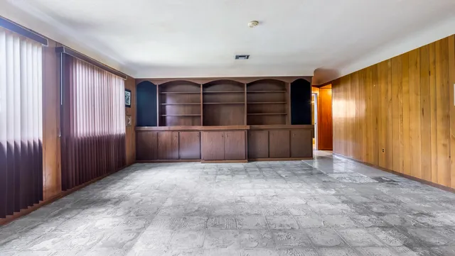 a view of an empty room with a fireplace