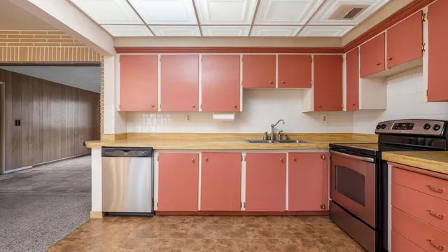 a kitchen with stainless steel appliances granite countertop a refrigerator and sink