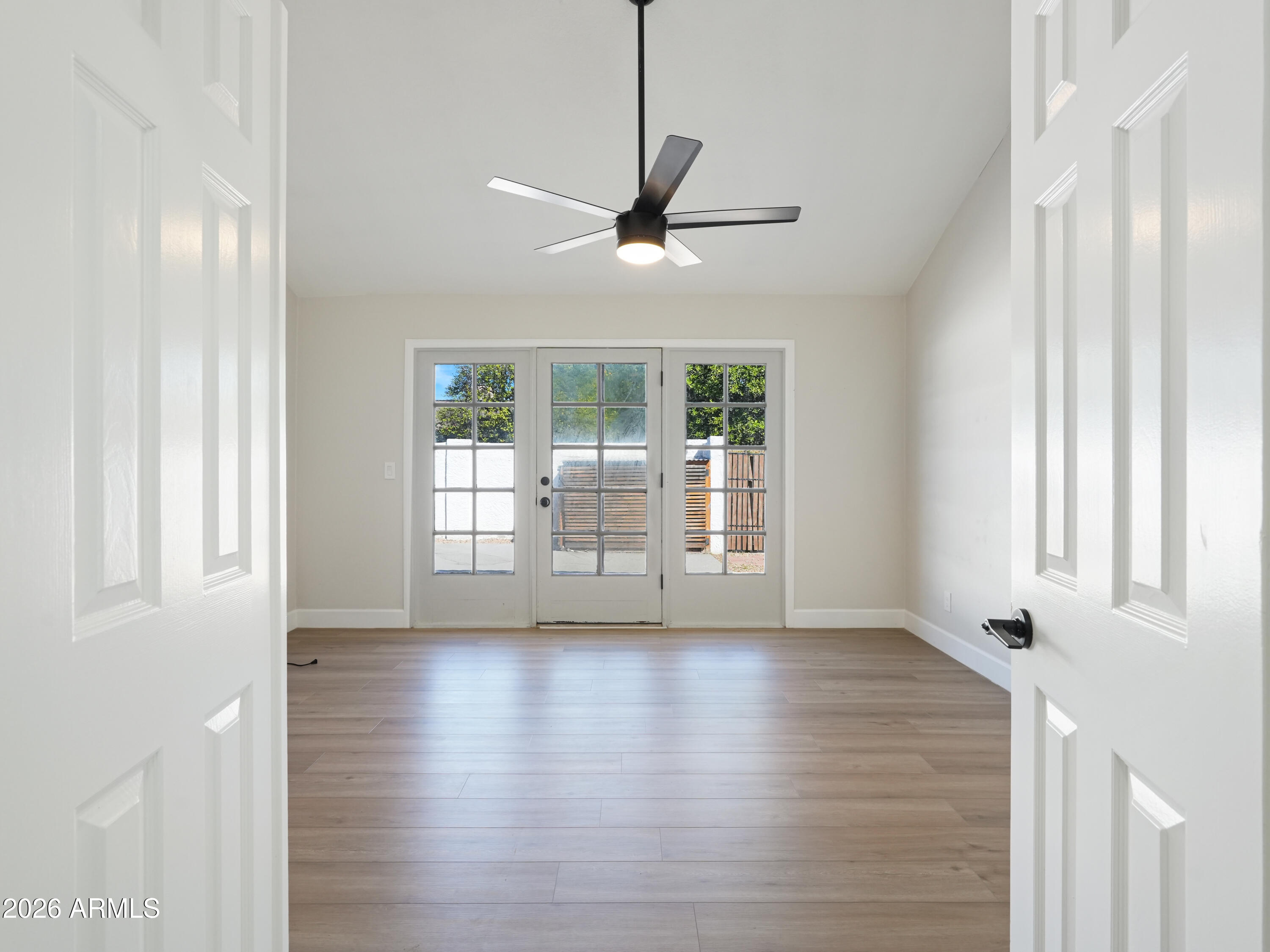 1960 East Krista Way Tempe, AZ 85284 - Photo 16 of 36 a view of an empty room with wooden floor and a window