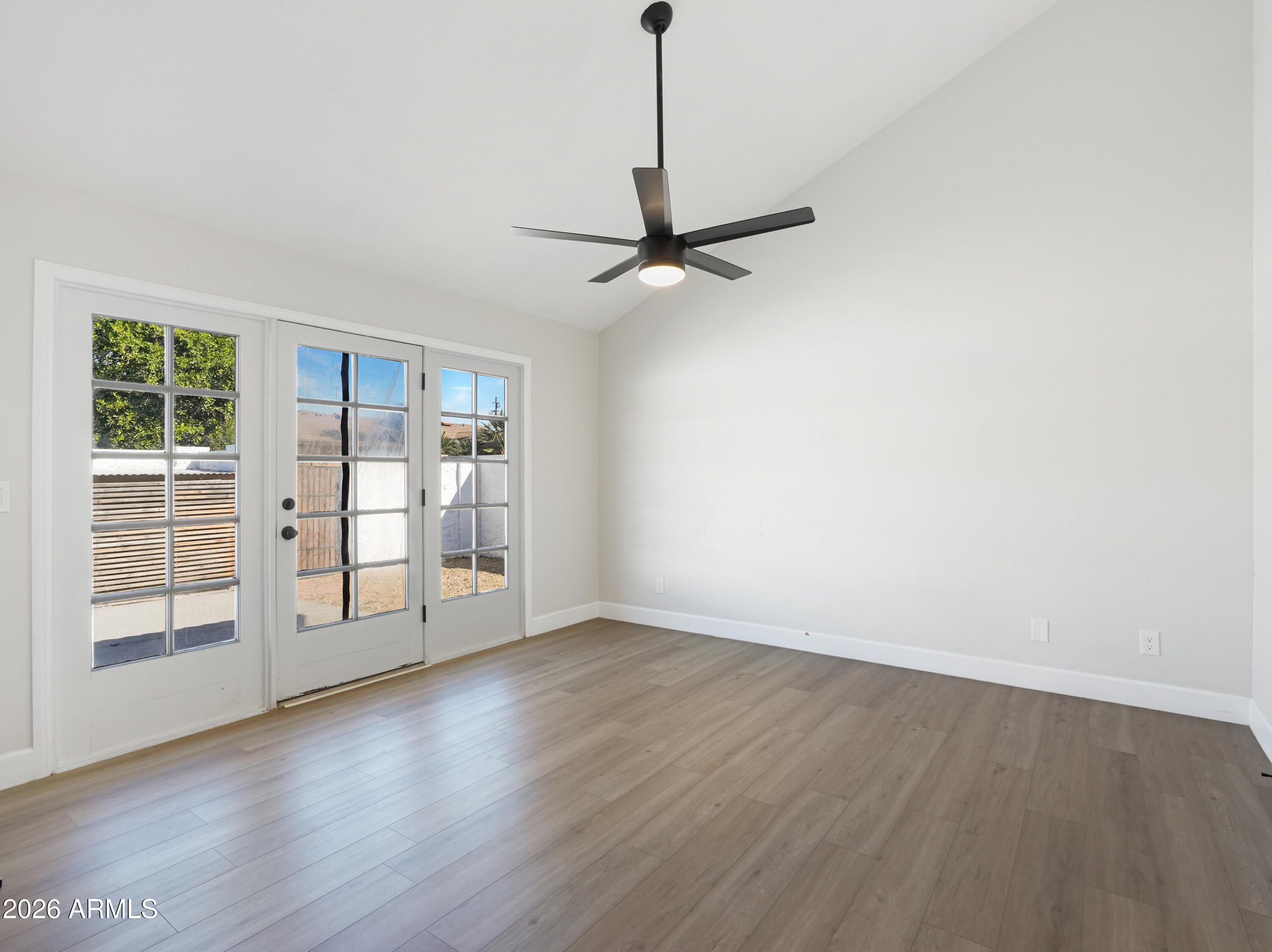 1960 East Krista Way Tempe, AZ 85284 - Photo 17 of 36 a view of an empty room with a window and wooden floor
