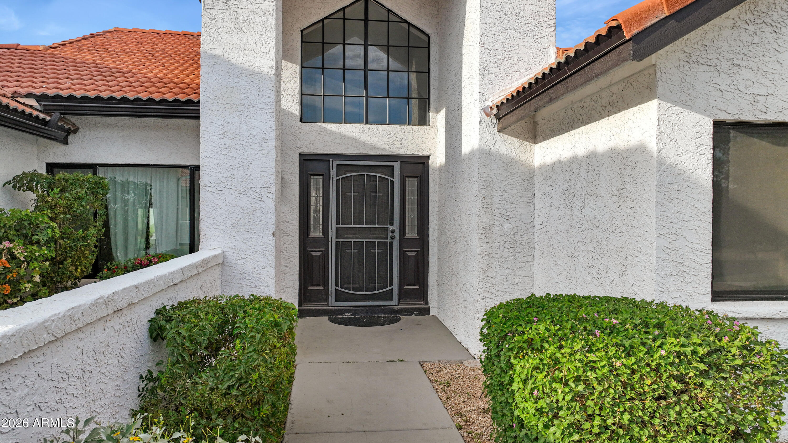1960 East Krista Way Tempe, AZ 85284 - Photo 2 of 36 a front view of a house with a garden