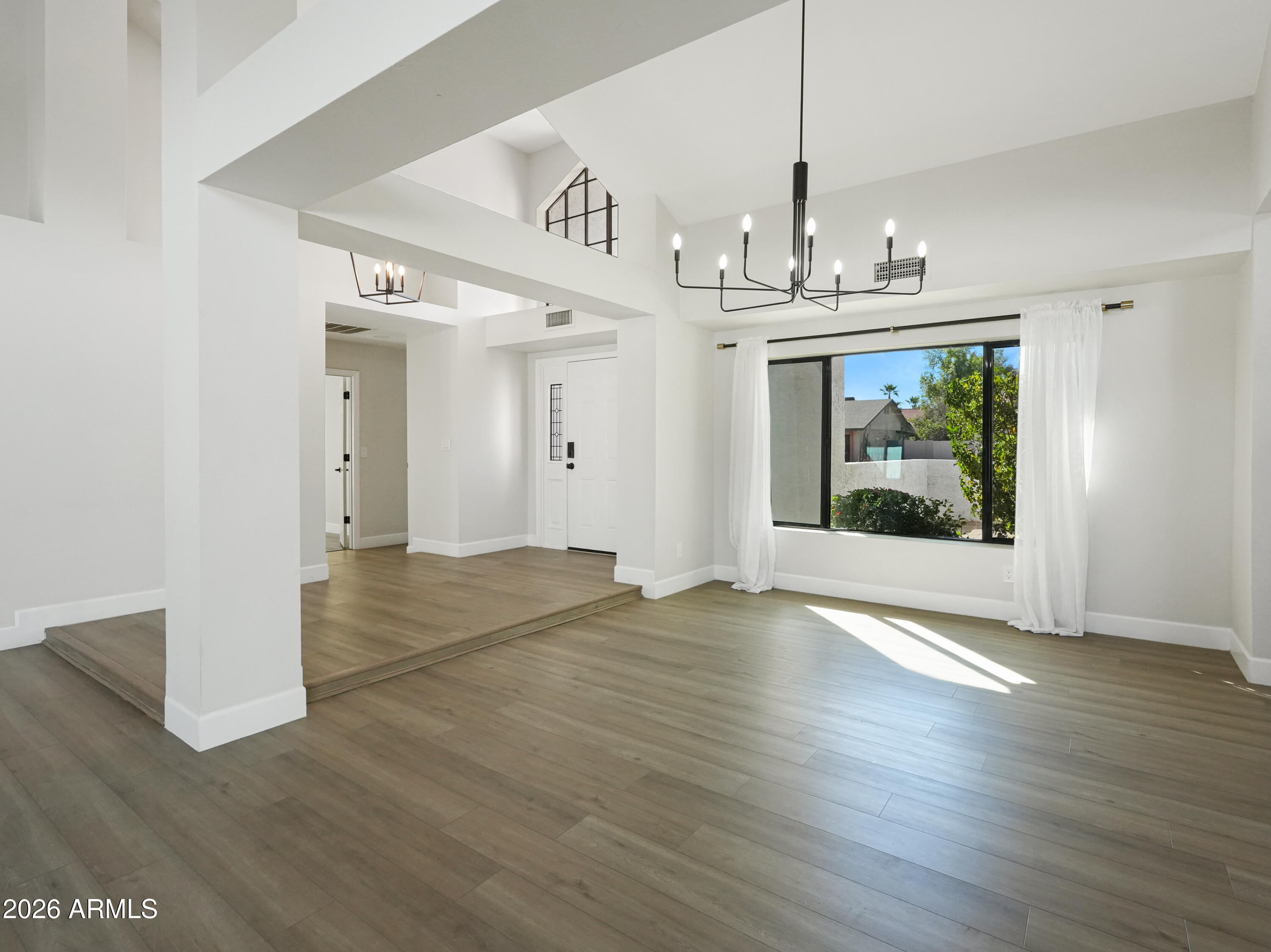 1960 East Krista Way Tempe, AZ 85284 - Photo 5 of 36 a view of a room with wooden floor chandelier and windows
