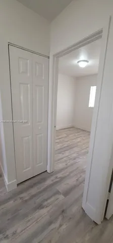 a view of a room with wooden floor