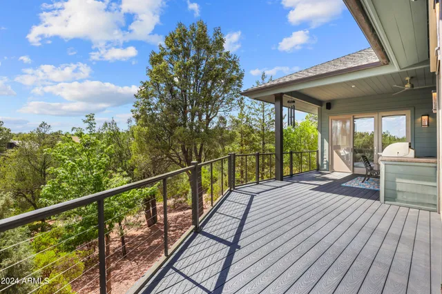 a bathroom with a granite countertop sink a mirror and shower