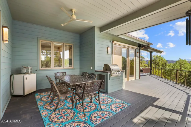a living room with furniture and a ceiling fan