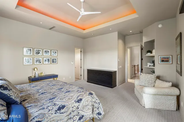 a living room with furniture and a ceiling fan