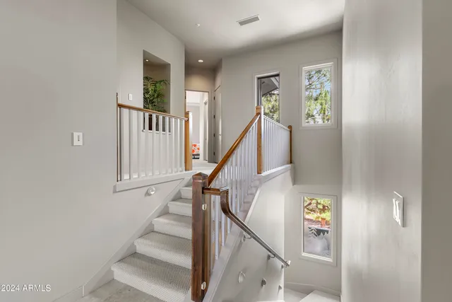 a view of a hallway with closet and a bathroom