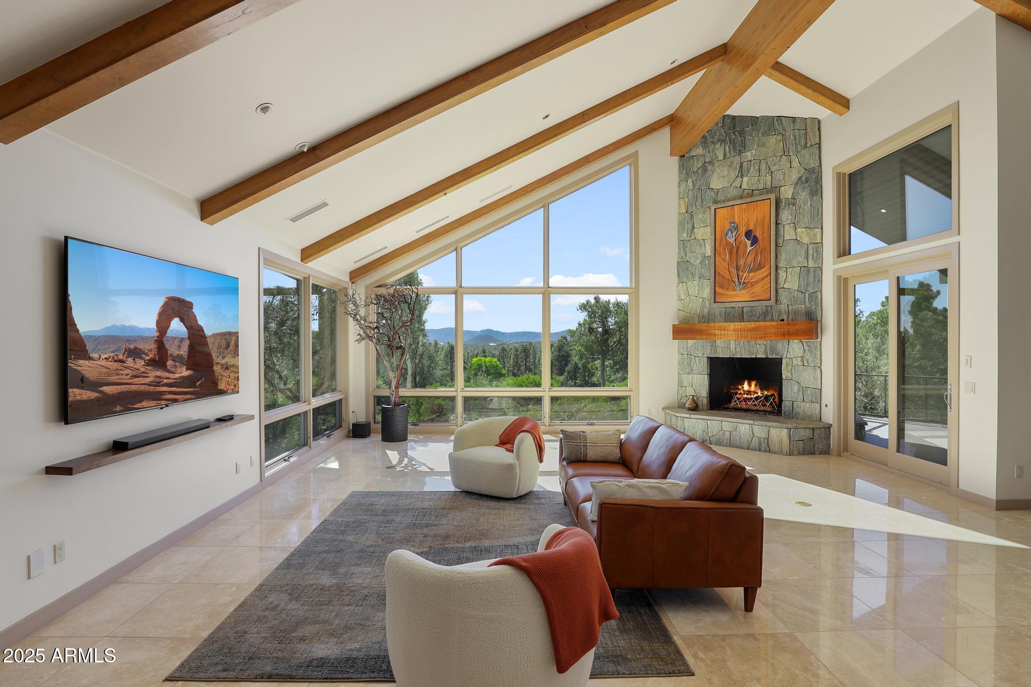2203 East Scenic Drive Payson, AZ 85541 - Photo 3 of 74 a living room with furniture a fireplace and a flat screen tv