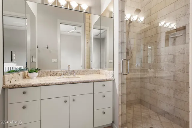 a view of a brick house with large windows and a large tree