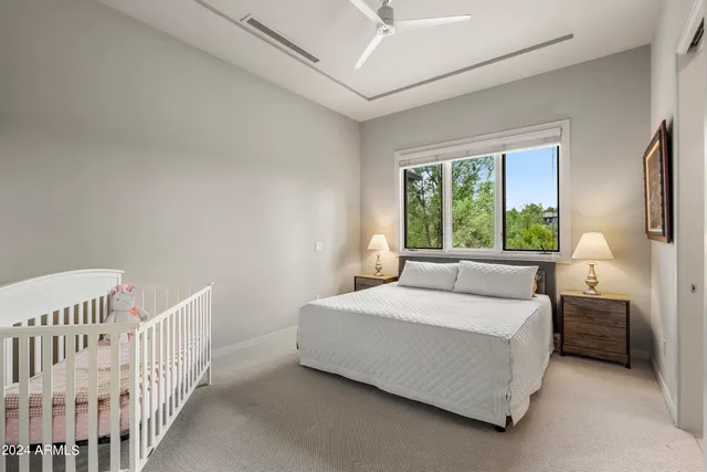 an aerial view of a house with a yard and large tree
