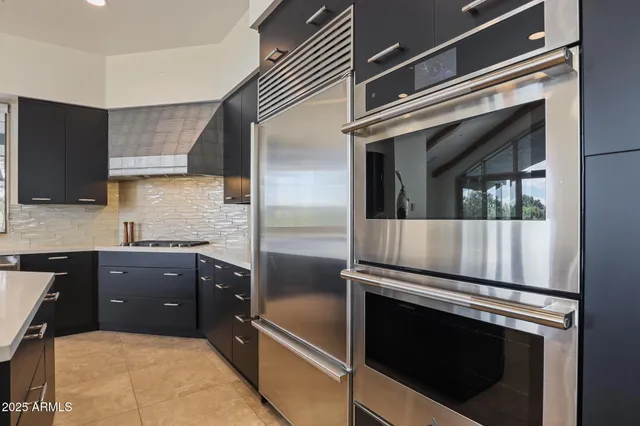 a living room with furniture a fireplace and a large window
