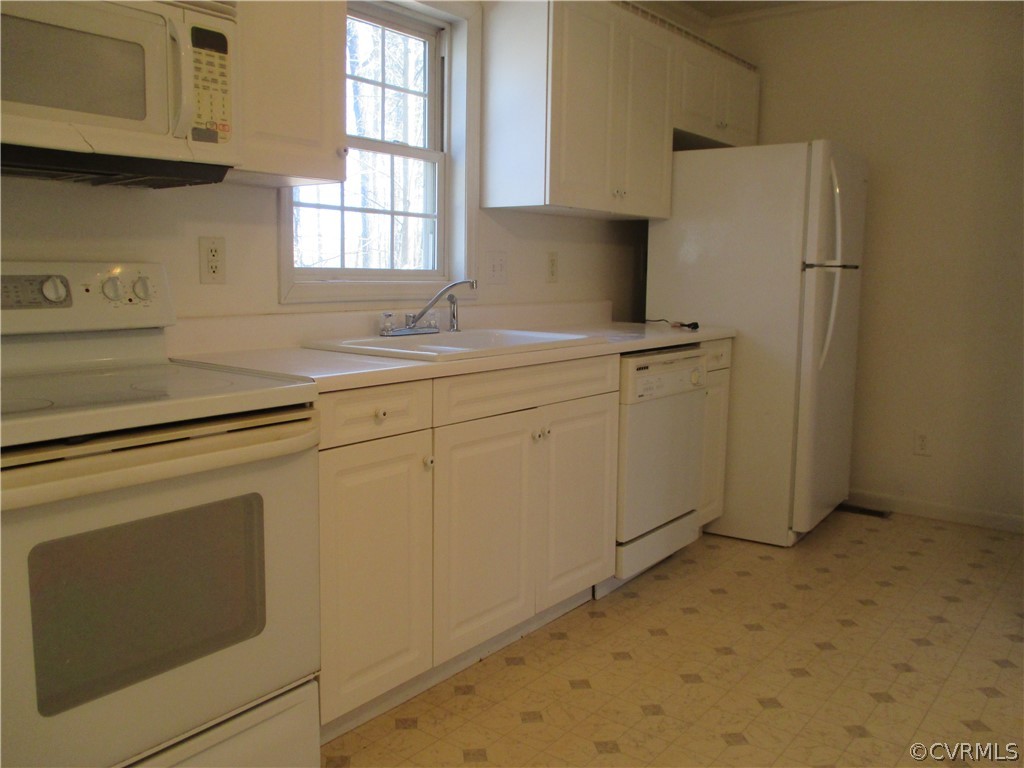 62 Falls Road Victoria, VA 23974 - Photo 25 of 36 a kitchen with stainless steel appliances white cabinets and a refrigerator