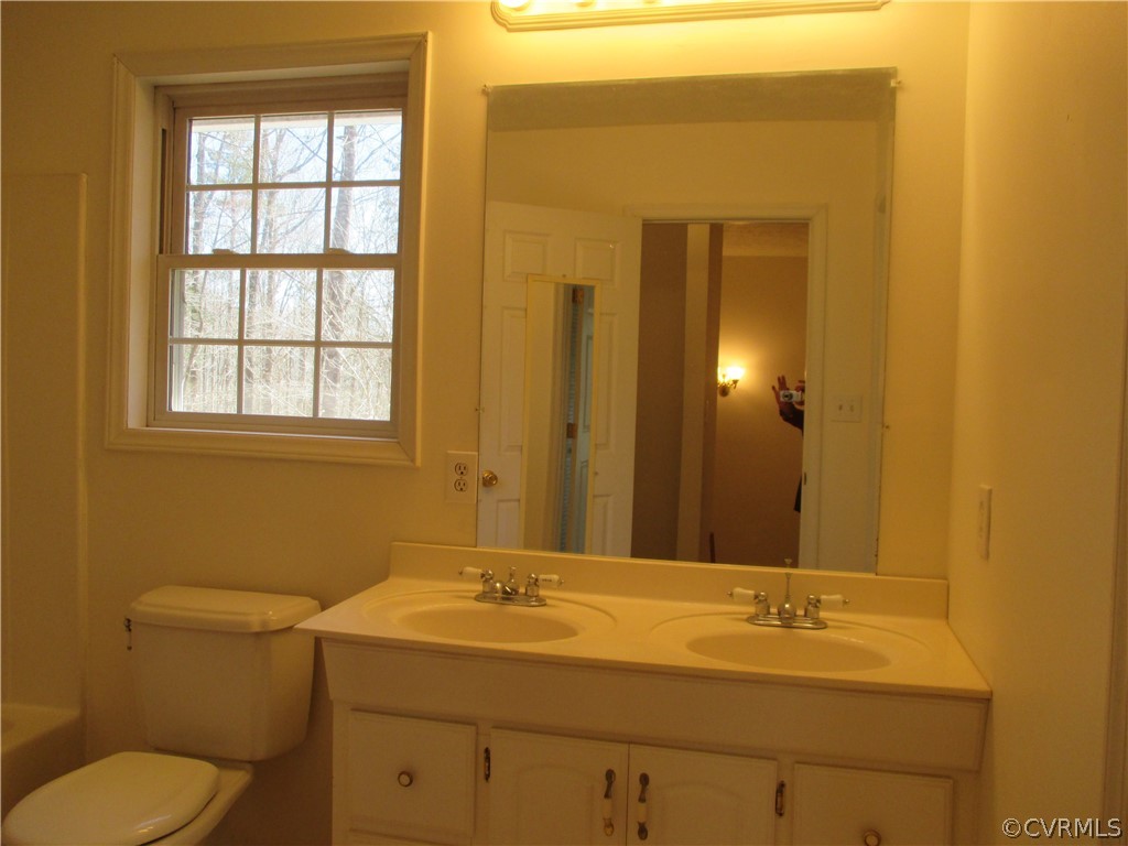62 Falls Road Victoria, VA 23974 - Photo 34 of 36 a bathroom with a granite countertop sink toilet and mirror