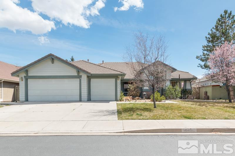 9970 Bandana Way Reno, NV 89521 - Photo 1 of 32 a front view of a house with a yard and garage