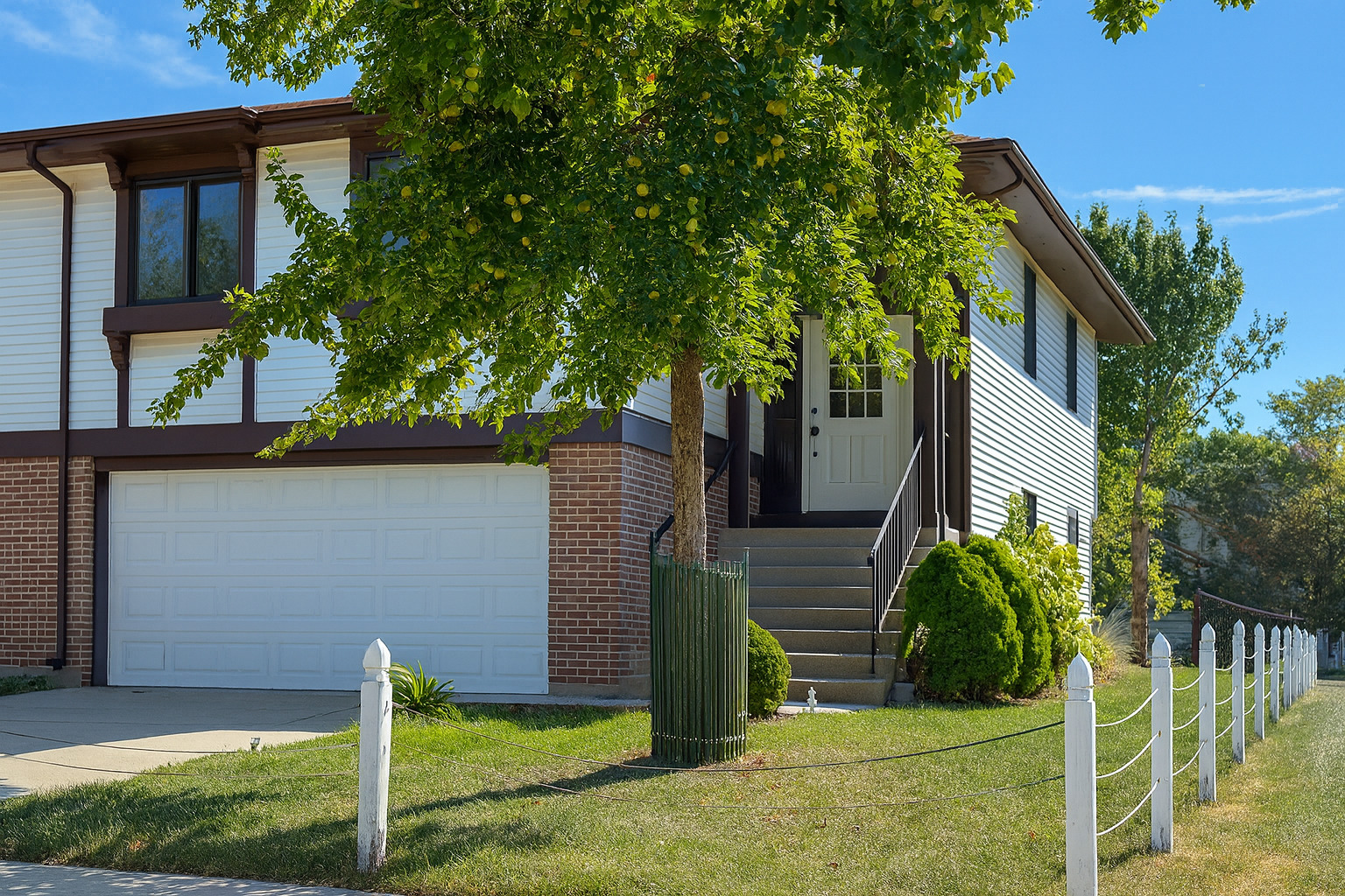 front view of a house with a tree