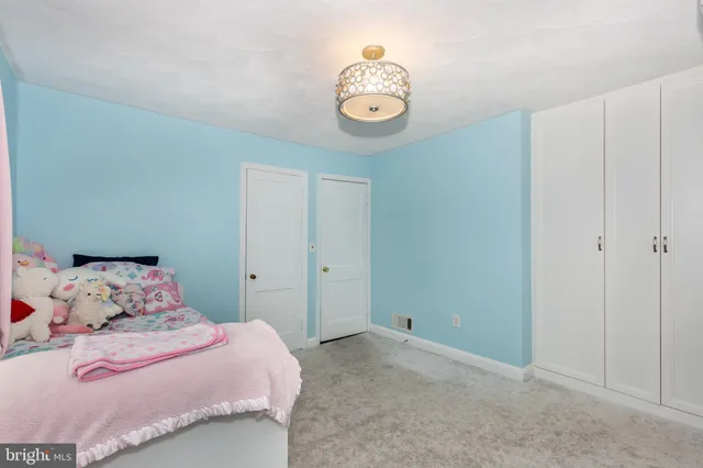 a bedroom with a bed and chandelier