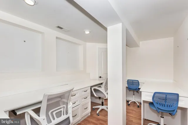 a view of room with furniture and wooden floor