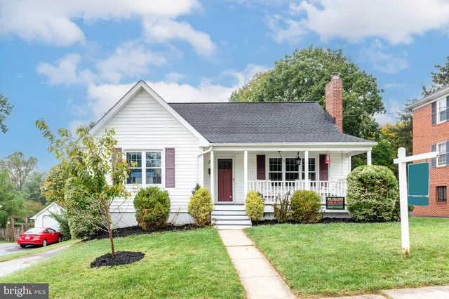 a front view of a house with a garden and plants