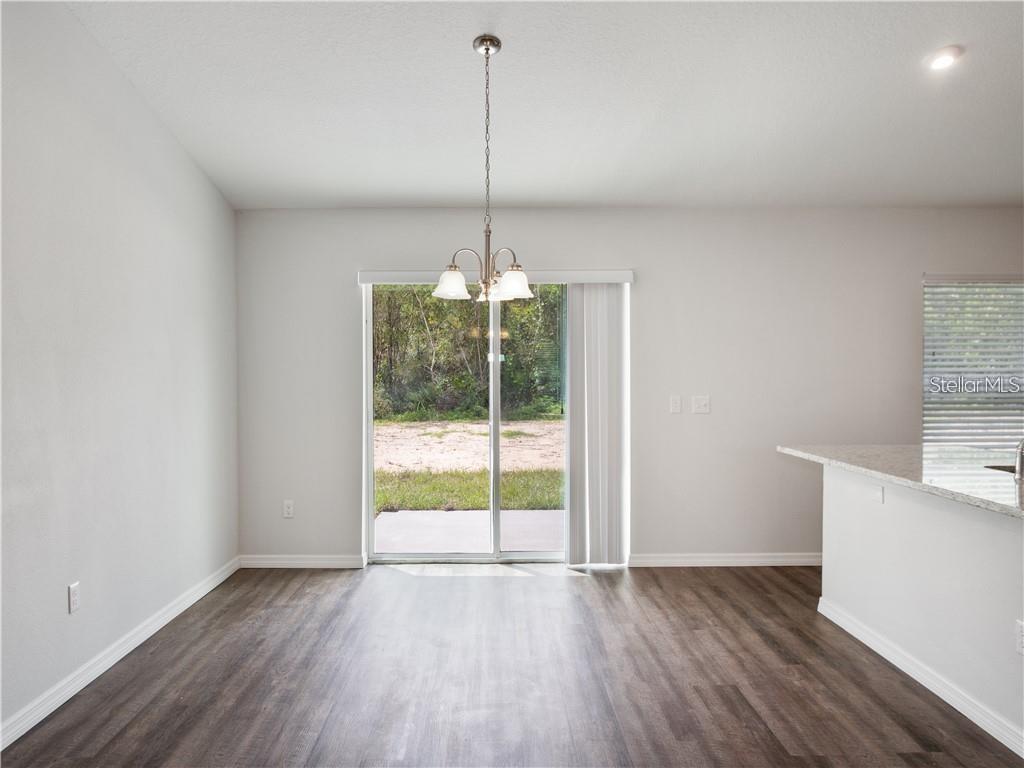 17399 Southwest 25th Circle Ocala, FL 34473 - Photo 11 of 22 a view of an empty room with wooden floor and a window