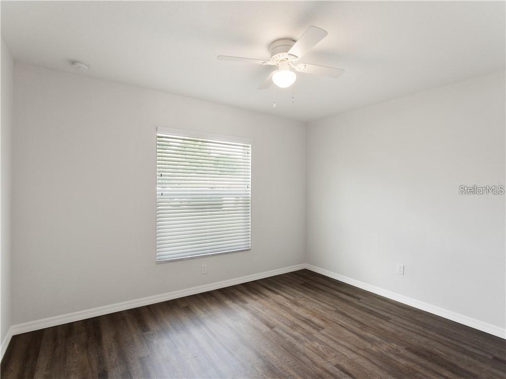 17399 Southwest 25th Circle Ocala, FL 34473 - Photo 13 of 22 an empty room with wooden floor and windows
