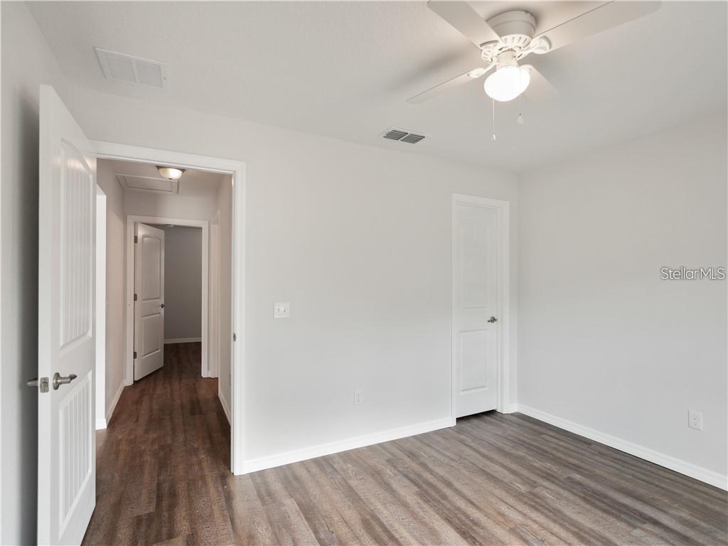 17399 Southwest 25th Circle Ocala, FL 34473 - Photo 15 of 22 wooden floor in an empty room with a window