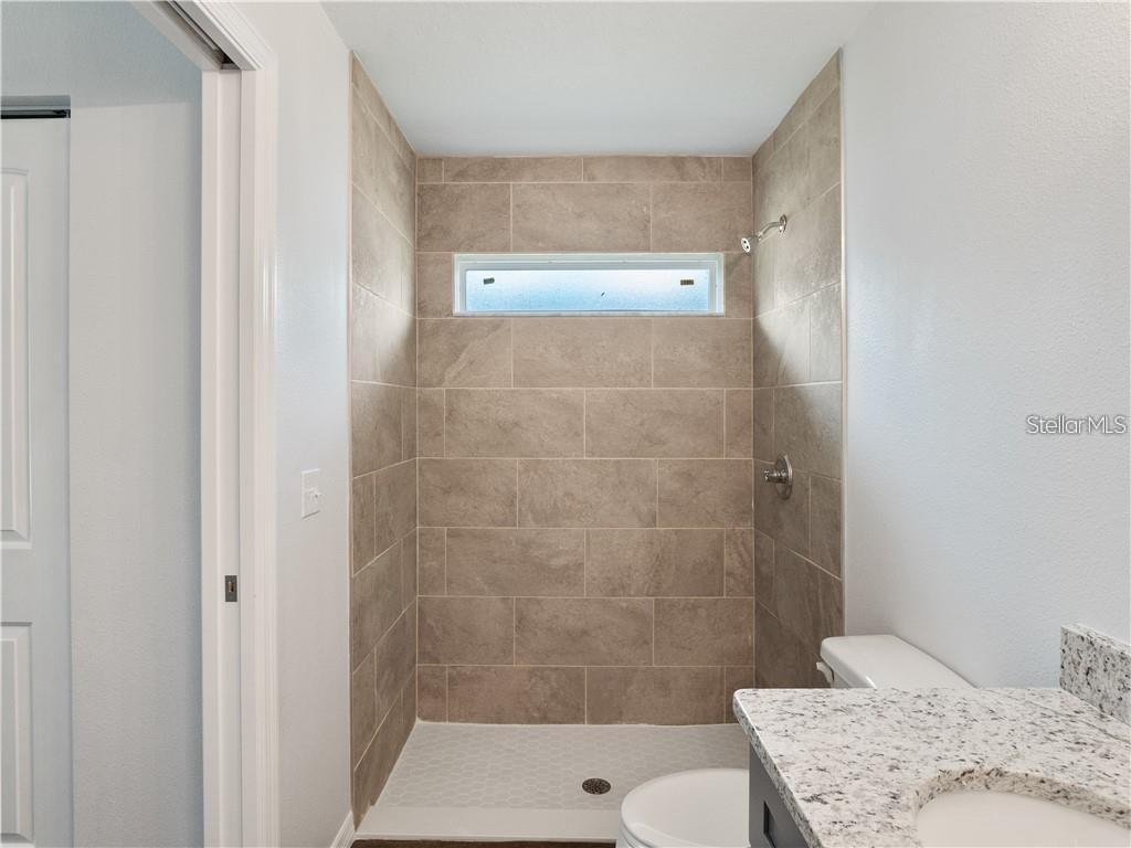 17399 Southwest 25th Circle Ocala, FL 34473 - Photo 18 of 22 a bathroom with a sink and a shower
