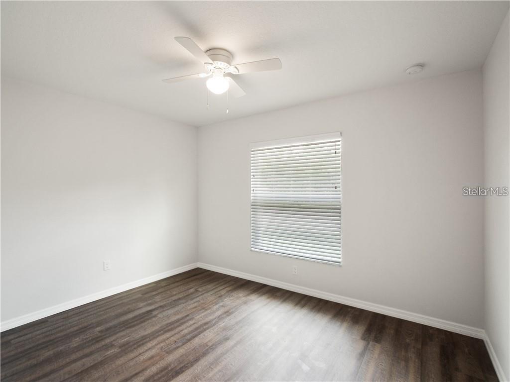17399 Southwest 25th Circle Ocala, FL 34473 - Photo 20 of 22 an empty room with wooden floor and windows