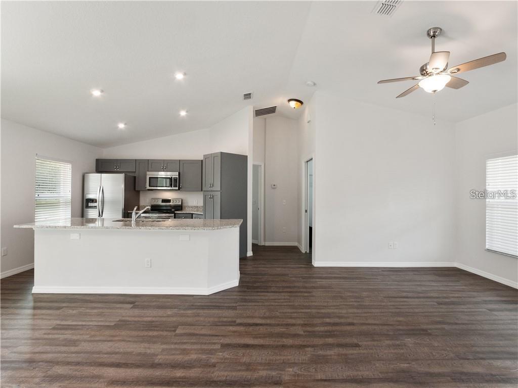 17399 Southwest 25th Circle Ocala, FL 34473 - Photo 9 of 22 a view of kitchen and living room with wooden floor