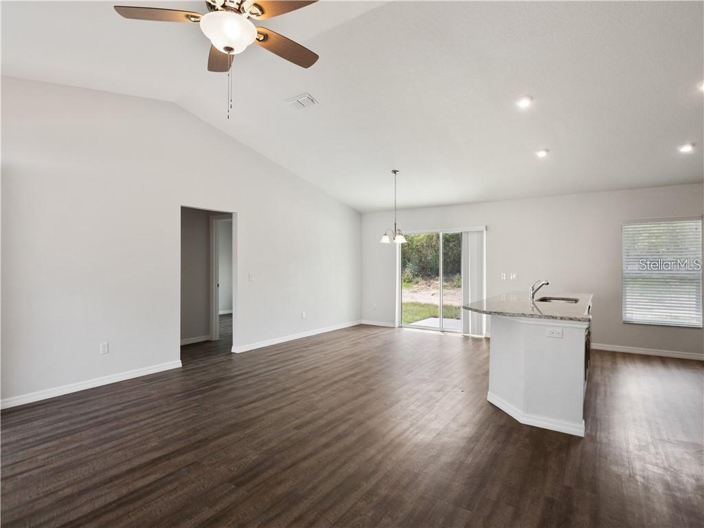 17399 Southwest 25th Circle Ocala, FL 34473 - Photo 10 of 22 a view of an empty room with wooden floor and a window